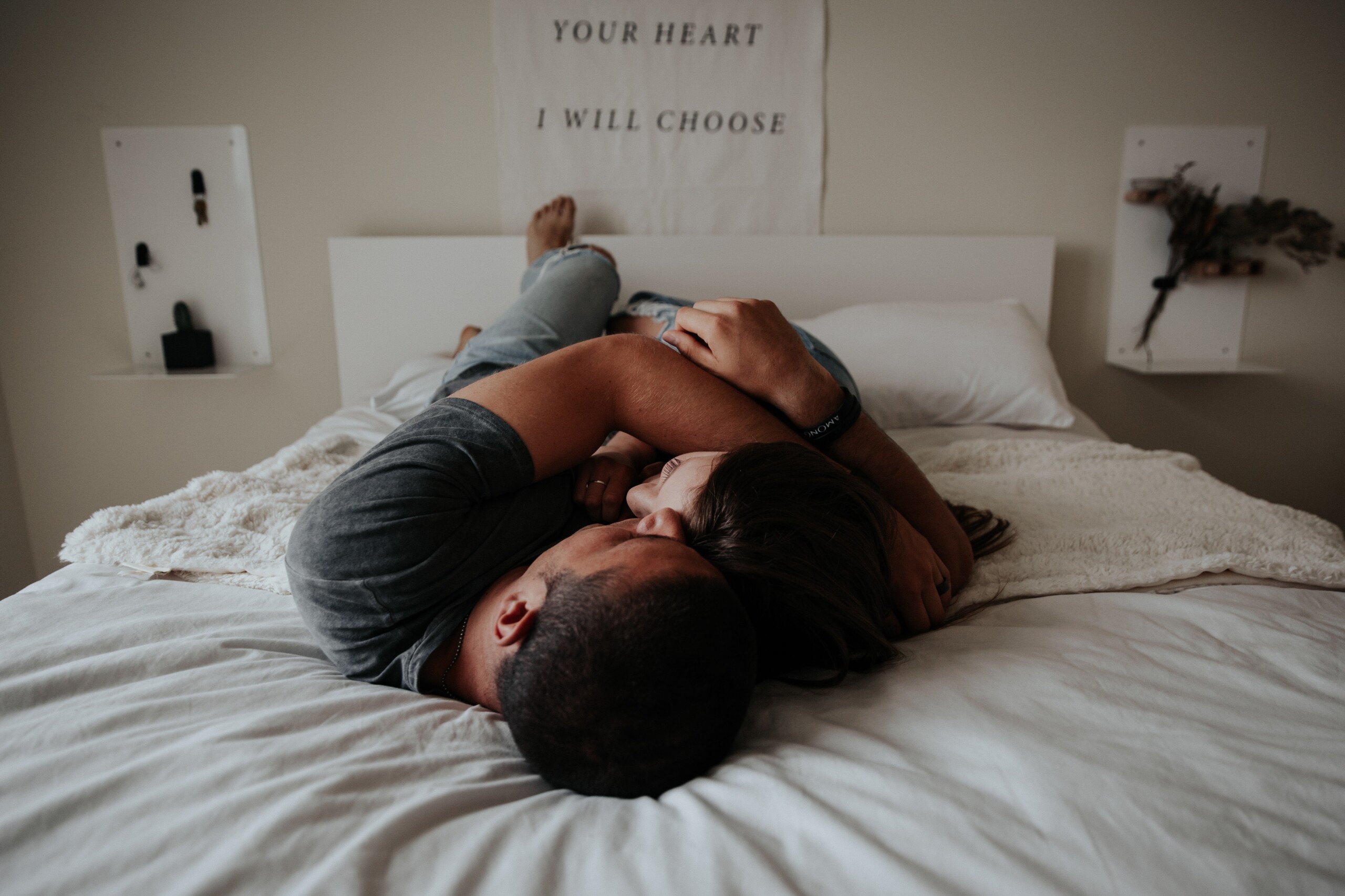 couple on bed in intimate embrace