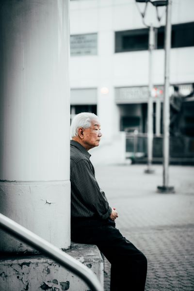 man sitting on ledge staring into the distance
